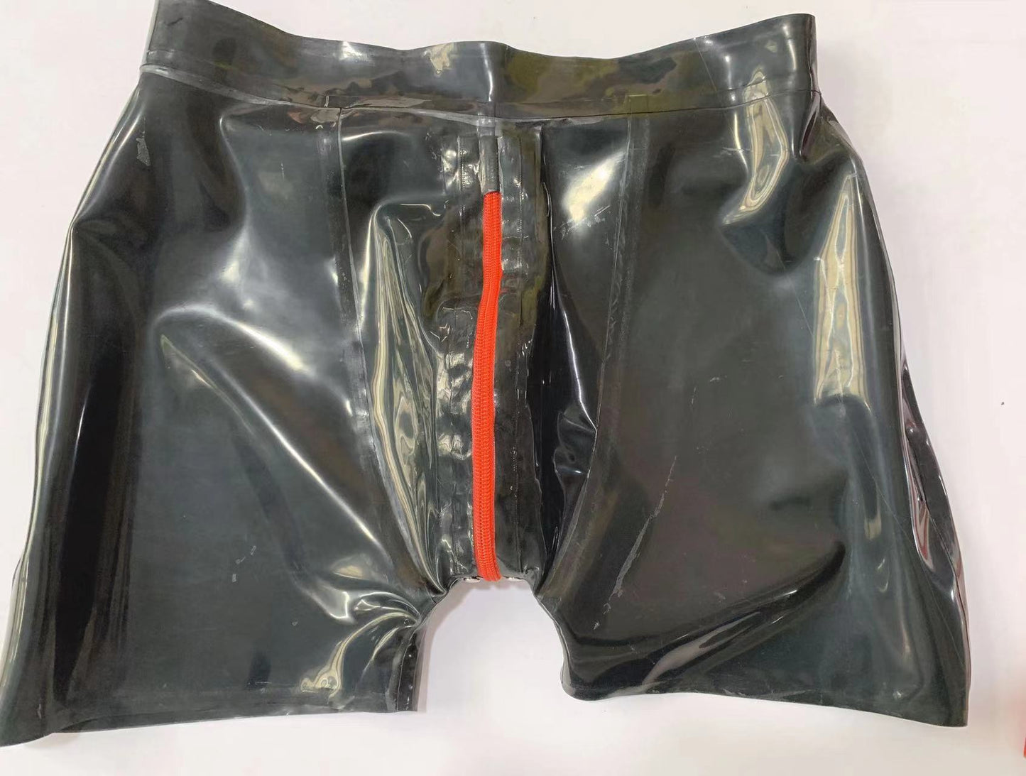 a black latex shorts with zipper
