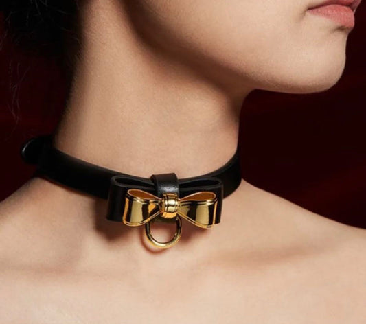 a black sex collar and leash with bow