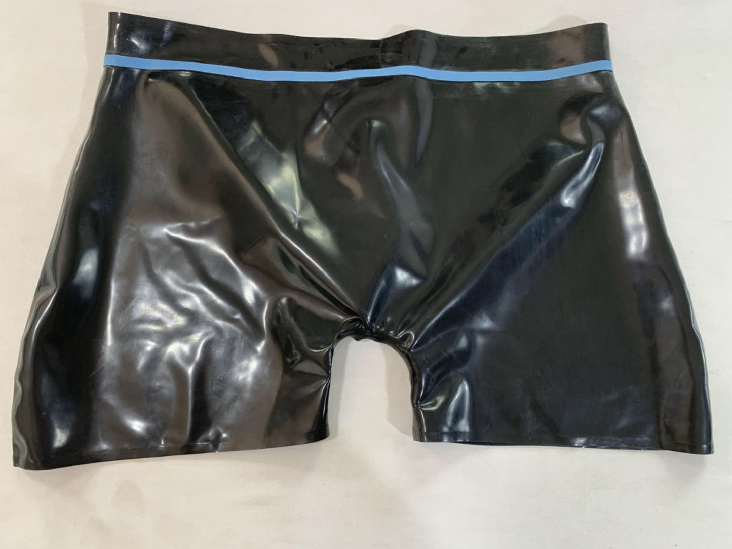 a black mens latex underwear with ring hole