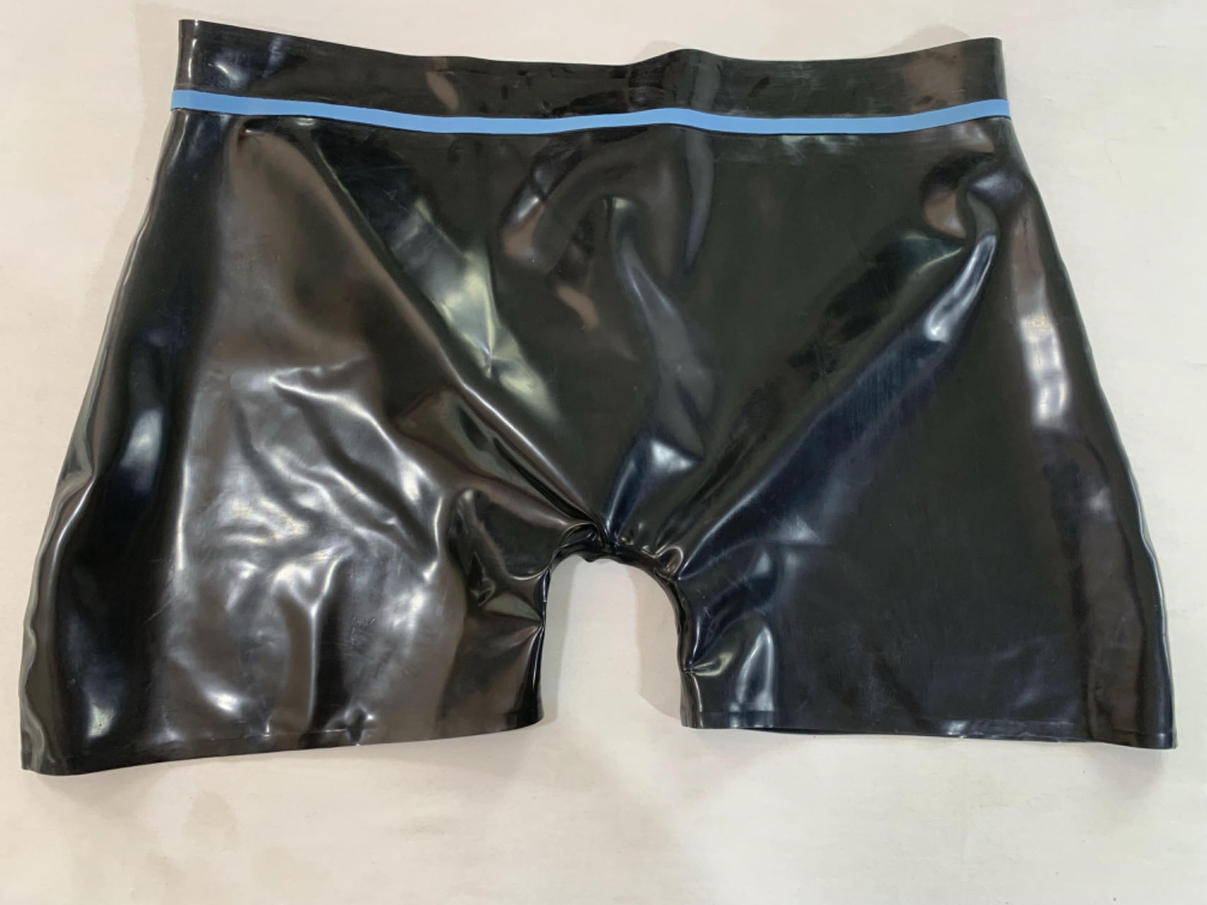 a black mens latex underwear with ring hole