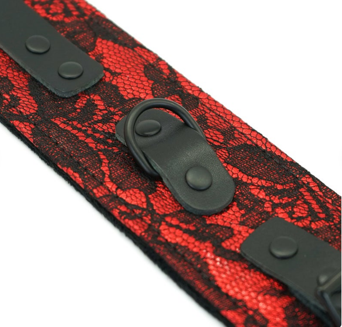 A pair of red and black bondage handcuffs with a chain link connection